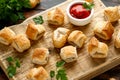 Pork sausage rolls with mustard and ketchup sauce on wooden board Royalty Free Stock Photo