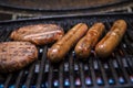 Grilled Sausages And Burgers On Portable Bbq