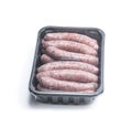 Pork sausages chipolatas in plastic pack isolated on white Royalty Free Stock Photo