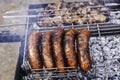 Pork sausages fried on coals on the grill Royalty Free Stock Photo