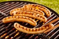 Pork sausages grilling on a portable BBQ Royalty Free Stock Photo