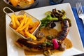 Pork sausages with mushrooms, french fries and lettuce Royalty Free Stock Photo