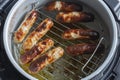 Pork sausages on a rack cooked in an air fryer. Healthy cooking concept