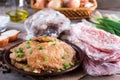 Pork schnitzel in a plate and frozen pork neck chops meat Royalty Free Stock Photo