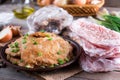 Pork schnitzel in a plate and frozen pork neck chops meat Royalty Free Stock Photo