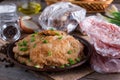 Pork schnitzel in a plate and frozen pork neck chops meat Royalty Free Stock Photo