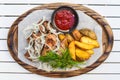 Pork shashlik with grilled vegetables served with salad and ketchup on wooden board Royalty Free Stock Photo