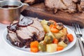 Pork shoulder in honey parmesan and soy souse, prepared in slow cooker or crockpot, served with carrot, potato and brussel cabbage Royalty Free Stock Photo