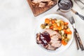 Pork shoulder in honey parmesan and soy souse, prepared in slow cooker or crockpot, served with carrot, potato and brussel cabbage Royalty Free Stock Photo