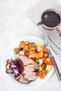 Pork shoulder in honey parmesan and soy souse, prepared in slow cooker or crockpot, served with carrot, potato and brussel cabbage Royalty Free Stock Photo