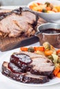 Pork shoulder in honey parmesan and soy souse, prepared in slow cooker or crockpot, served with carrot, potato and brussel cabbage Royalty Free Stock Photo