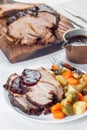 Pork shoulder in honey parmesan and soy souse, prepared in slow cooker or crockpot, served with carrot, potato and brussel cabbage Royalty Free Stock Photo