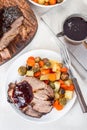 Pork shoulder in honey parmesan and soy souse, prepared in slow cooker or crockpot, served with carrot, potato and brussel cabbage Royalty Free Stock Photo