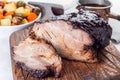 Pork shoulder in honey parmesan and soy souse, prepared in slow cooker or crockpot, on wooden board, horizontal