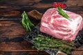 Pork Shoulder raw meat for fresh steaks on wooden cutting board with butcher cleaver. Dark wooden background. Top view Royalty Free Stock Photo