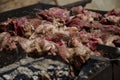 Pork skewers from pieces of meat on skewers during cooking on a charcoal grill