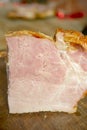 Pork slicing. Smoked pork belly in section. A piece of smoked balyk on a wooden board. Royalty Free Stock Photo
