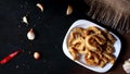 pork snack, pork rind, pork scratching, pork crackling on a dark wooden background. Top view