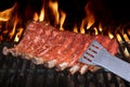 Pork Spare Ribs Barbecuing On The Flaming Charcoal Grill Royalty Free Stock Photo
