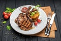 Pork steak with bone and potato pancakes Royalty Free Stock Photo