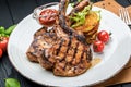 Pork steak with bone and potato pancakes Royalty Free Stock Photo