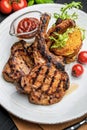 Pork steak with bone and potato pancakes