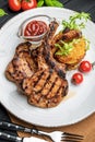 Pork steak with bone and potato pancakes Royalty Free Stock Photo