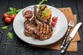 Pork steak with bone and potato pancakes Royalty Free Stock Photo