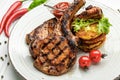 Pork steak with bone and potato pancakes