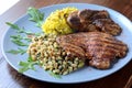 Pork steak with couscous and rice