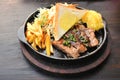 Pork steak with french fries and vegetables