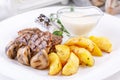 Pork steak with grilled champignons and potato slices. Royalty Free Stock Photo