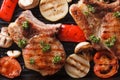 Pork steak grilled with onions and tomatoes. horizontal top view Royalty Free Stock Photo