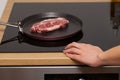 Pork steak in non-stick frying pan Royalty Free Stock Photo