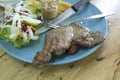 Pork steak in a plate with knife, fork and vegetables Royalty Free Stock Photo