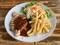 Pork steak with potato fried and salad