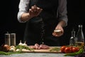 Pork steak and salt by the chef on the background. Horizontal photo. With vegetables, tomatoes, hot peppers, onions and chasnok. W Royalty Free Stock Photo