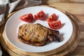 Pork steak and sliced tomato Royalty Free Stock Photo