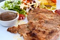 Pork steak with vegetable salads and sauces is a delicious