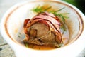 Pork tenderloin with bacon in white pan. Royalty Free Stock Photo