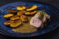 pork tenderloin with baked potatoes and French coarse mustard sauce Royalty Free Stock Photo