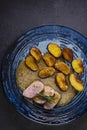 pork tenderloin with baked potatoes and French coarse mustard sauce Royalty Free Stock Photo