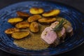 pork tenderloin with baked potatoes and French coarse mustard sauce Royalty Free Stock Photo