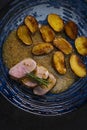 pork tenderloin with baked potatoes and French coarse mustard sauce Royalty Free Stock Photo