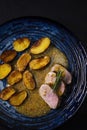 pork tenderloin with baked potatoes and French coarse mustard sauce Royalty Free Stock Photo