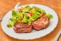 Pork tenderloin in dried ham steak with salad