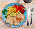 Pork tenderloin steaks with fried potatoes, baked pepper, parsley