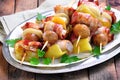 Pork wrapped in bacon on skewers grilled with onions, mushrooms and peppers. Royalty Free Stock Photo