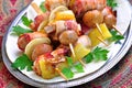 Pork wrapped in bacon on skewers grilled with onions, mushrooms and peppers. Royalty Free Stock Photo