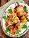 Pork wrapped in bacon on skewers grilled with onions, mushrooms and peppers. Royalty Free Stock Photo